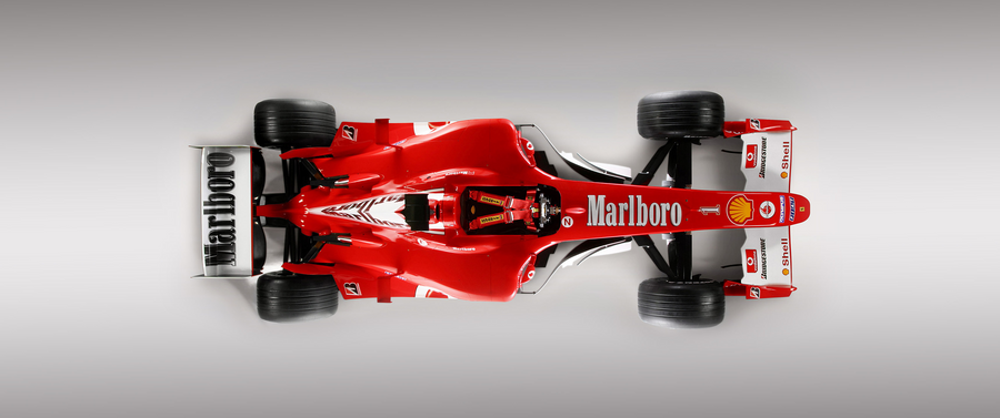Formula 1 – Classic Red from Above - a Formula 1 car in red with tobacco livery, shot against a clean studio ground, on a metal wall art plate