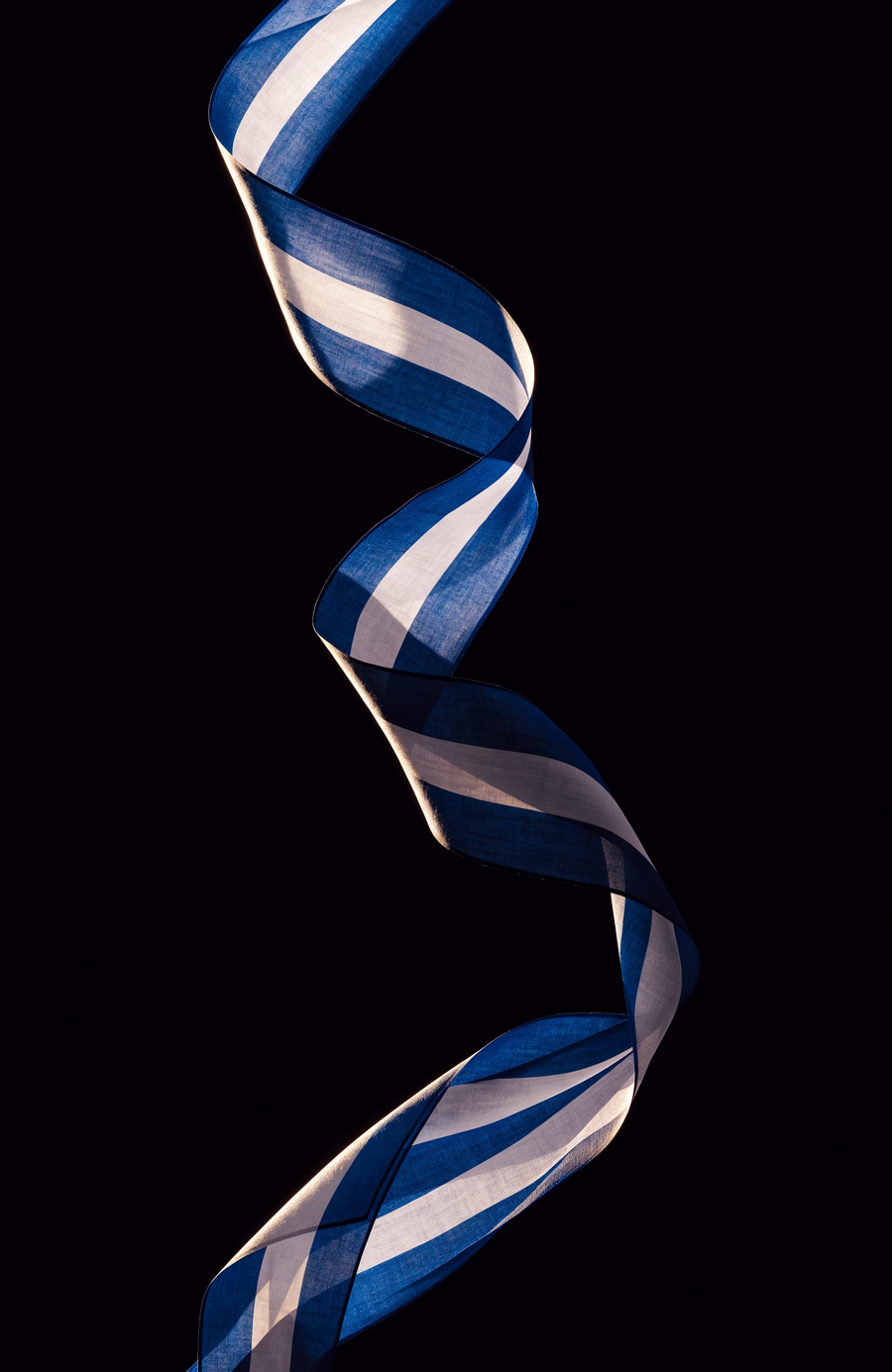 A ribbon of silk in Greek blue and white turns through the dark in a single long curve