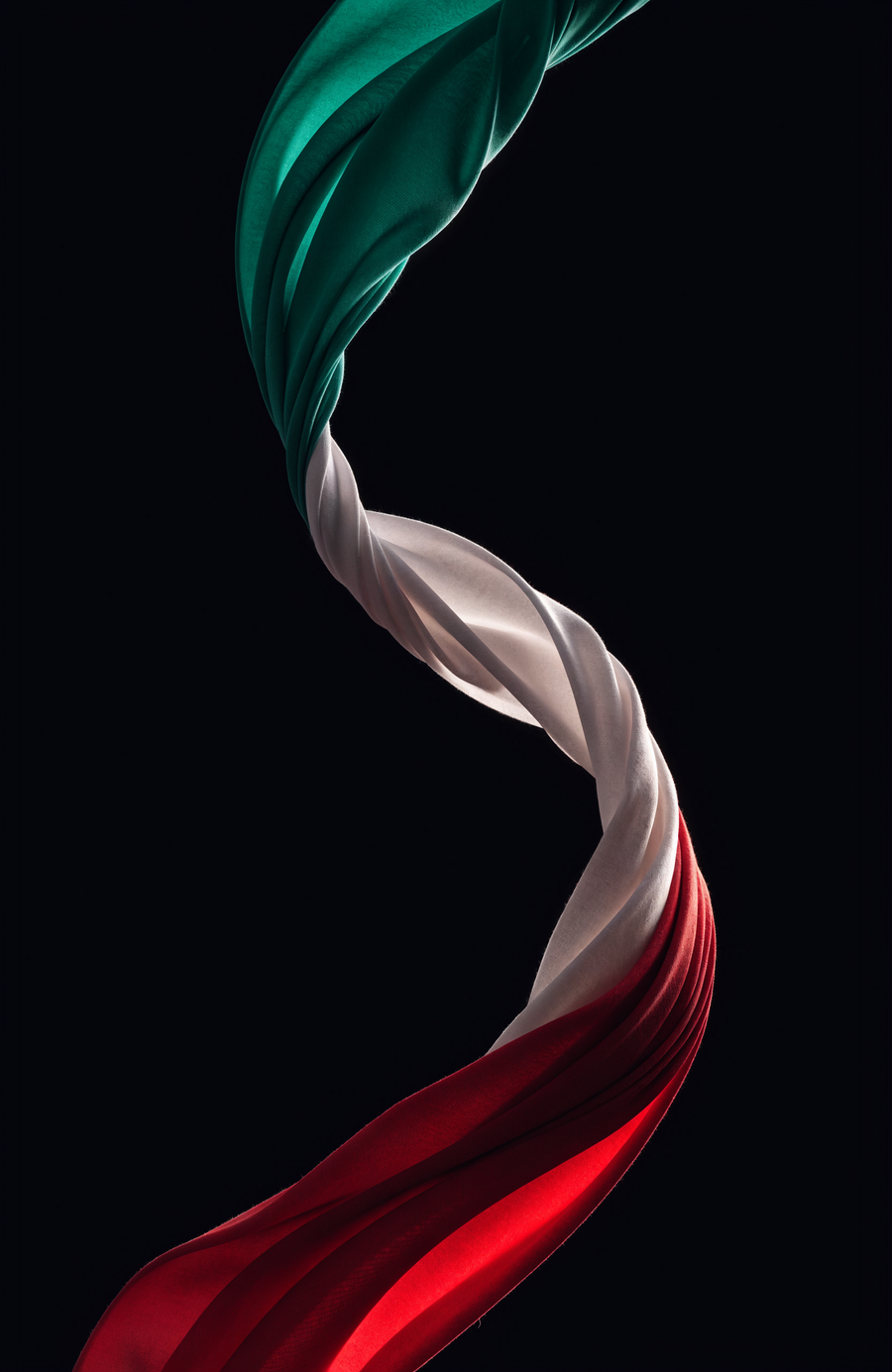 A ribbon of silk in Mexican green, white and red turns through the dark in a single long curve