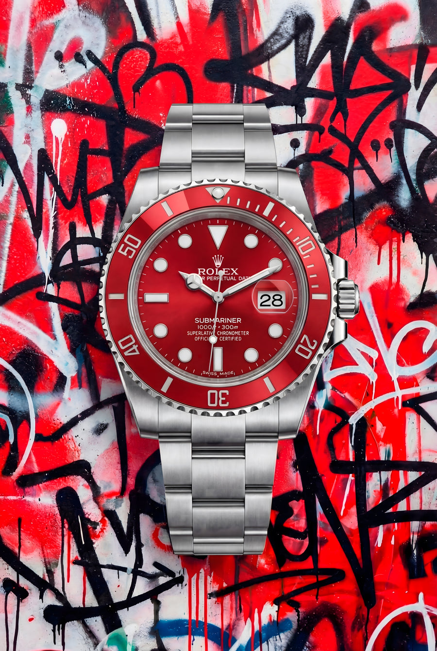 Rolex Submariner – Graffiti Red - a red-dial Submariner on red and white spray paint, black tags cutting across it, on a metal wall art plate