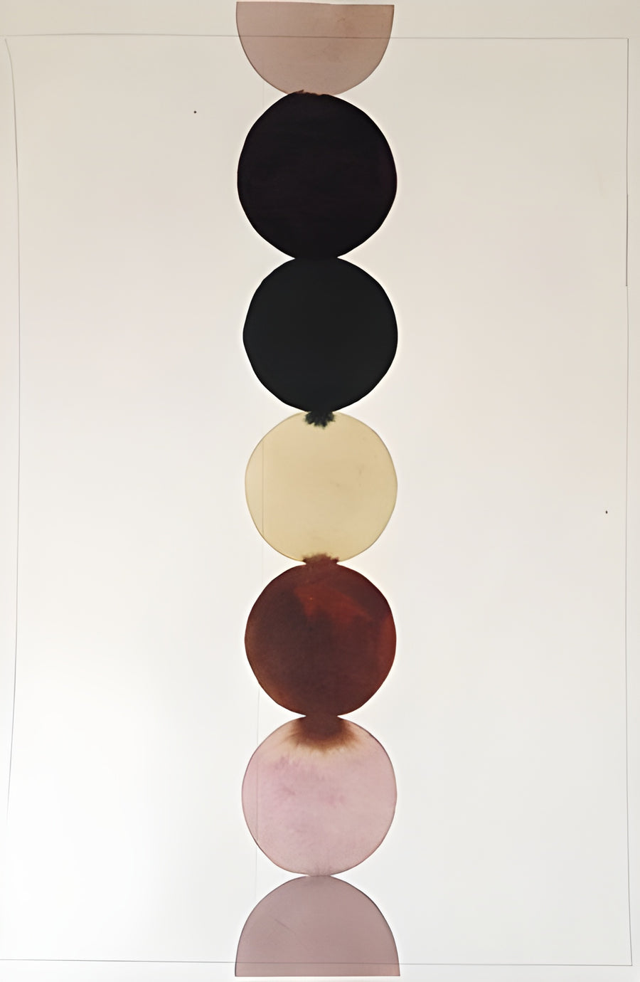 Stacked Circles - circles stacked one on another in black, cream, oxblood and dusty pink, on a metal wall art plate