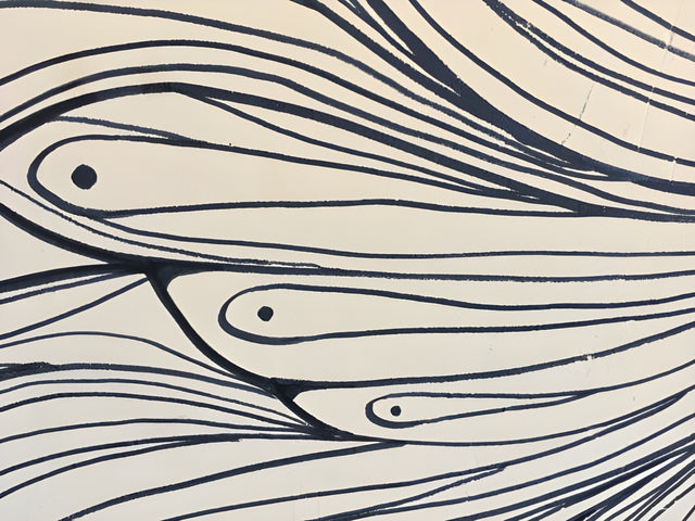 Fish Lines - fish carried along in a current of fine navy lines on cream, on a metal wall art plate