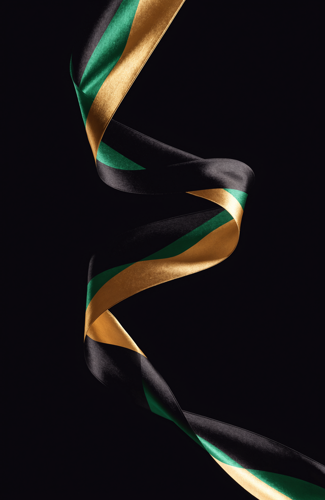 A ribbon of silk in Jamaican black, green and gold turns through the dark in a single long curve