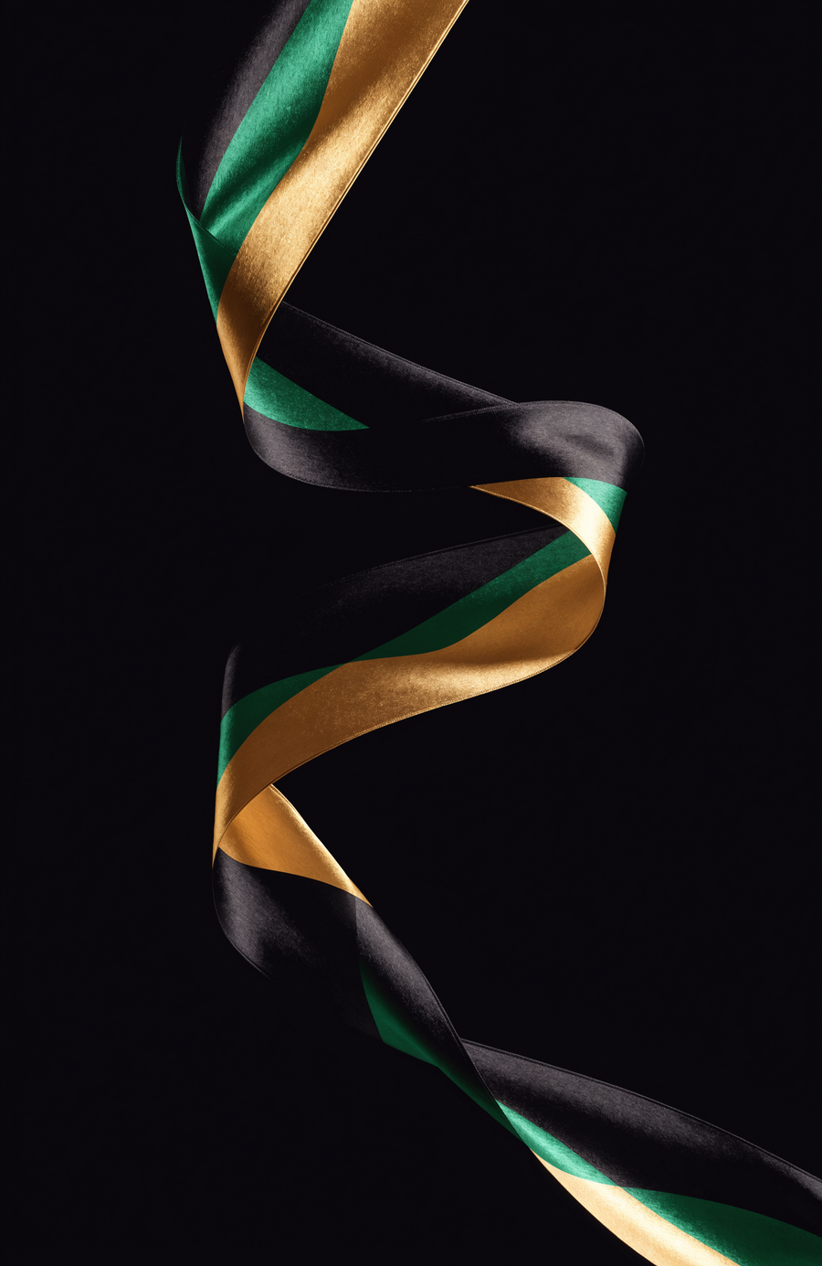 A ribbon of silk in Jamaican black, green and gold turns through the dark in a single long curve
