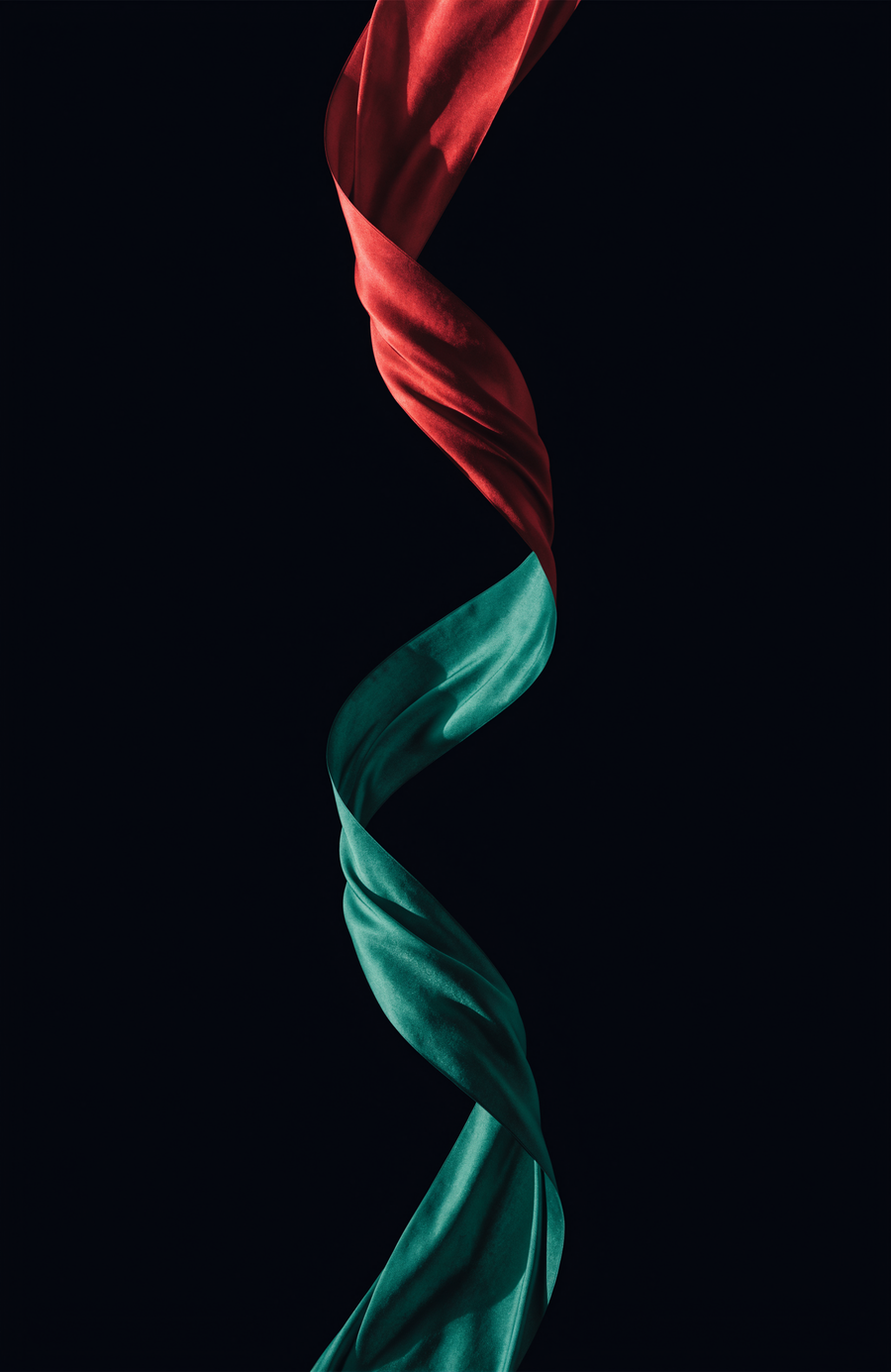 A ribbon of silk in Moroccan red and green turns through the dark in a single long curve
