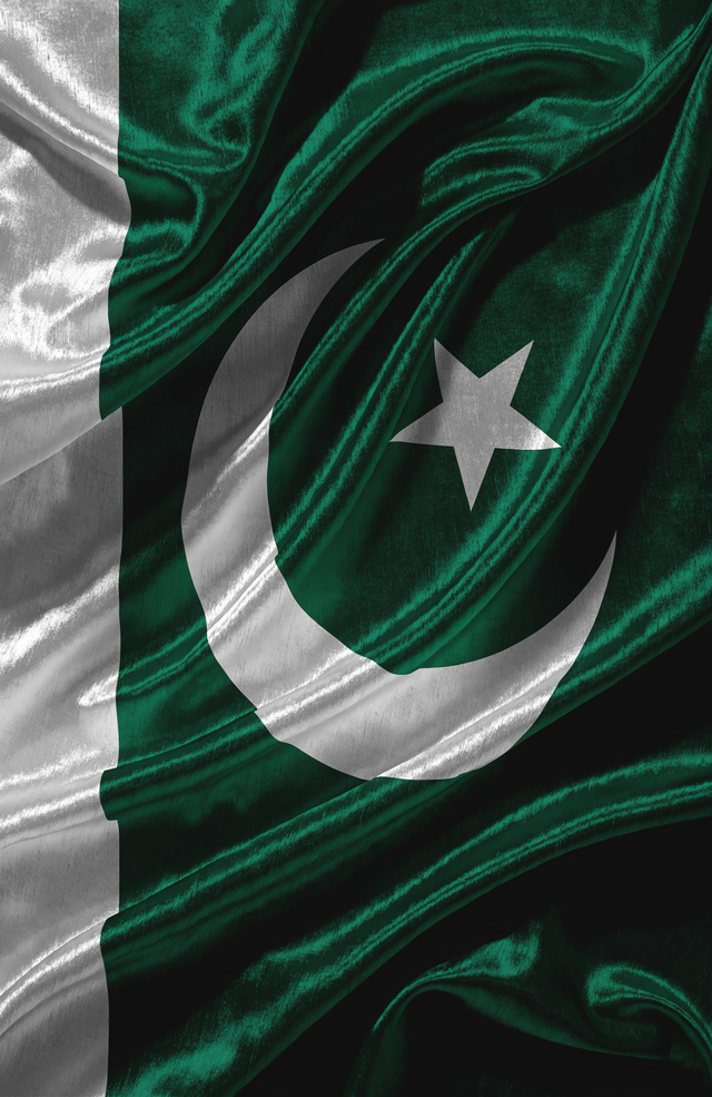 The Pakistani flag flows across deep green satin, the white crescent and star glowing against the folds